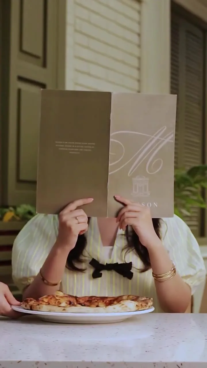 A guest reading the Maison menu